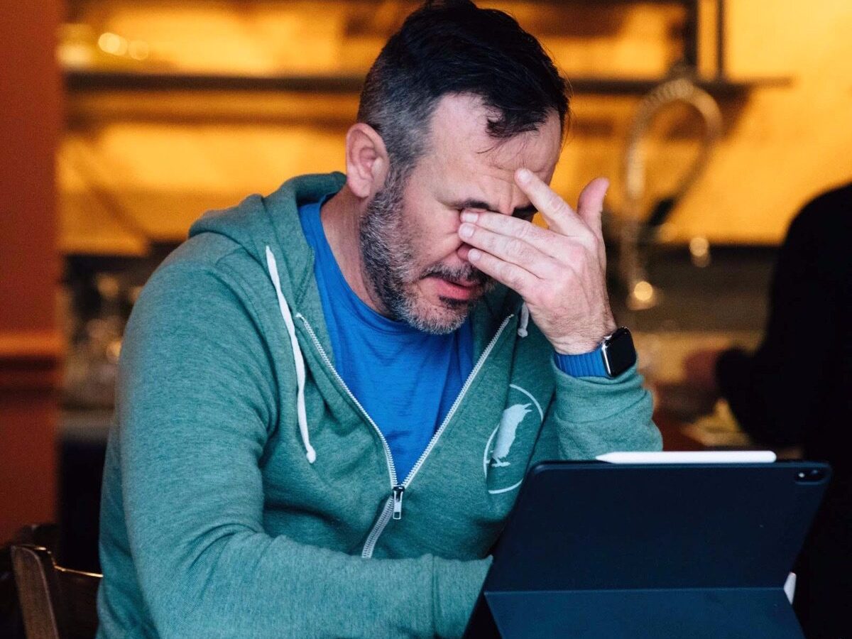 Zach Moores looking distressed covering his eyes.