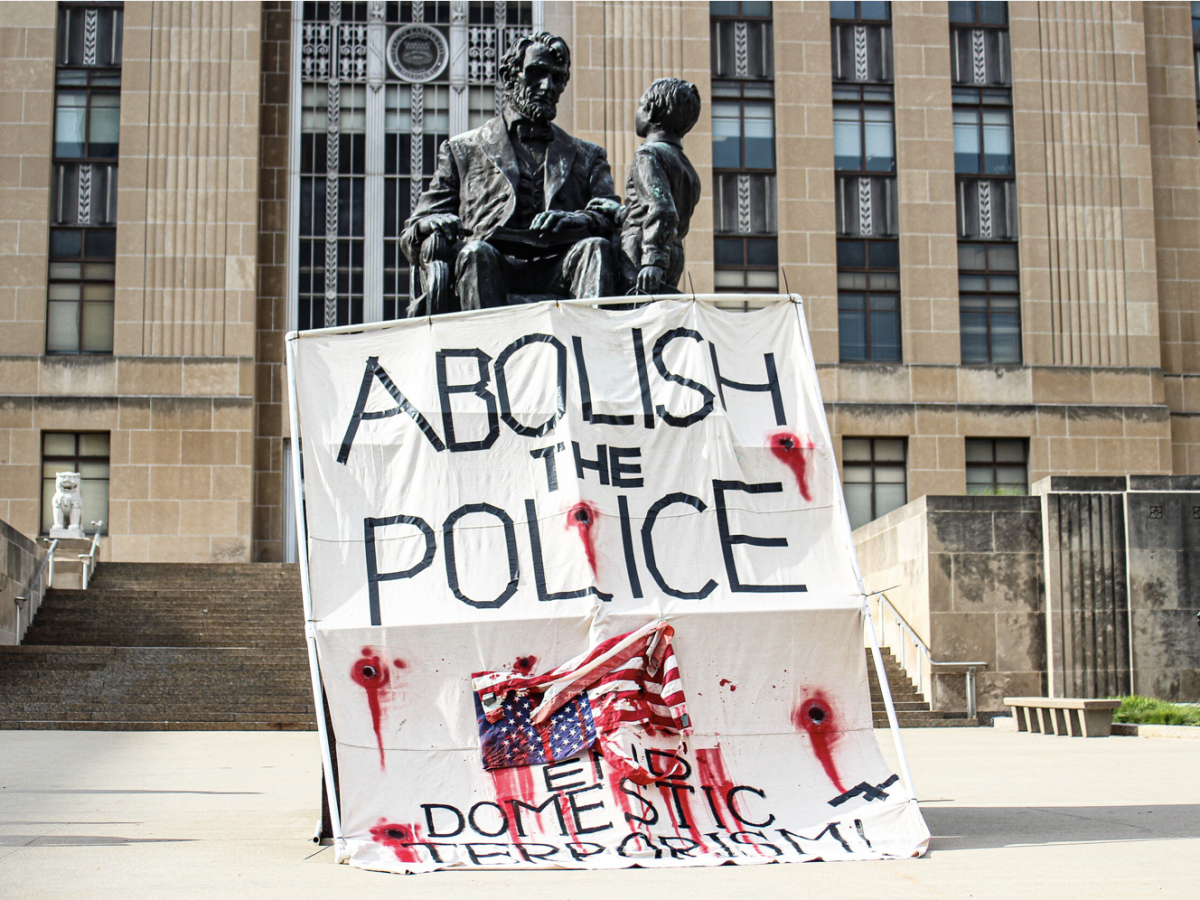 Members of One Struggle KC draped a banner over the statue of Abraham Lincoln during a demonstration outside of city hall on June 8, 2020. (Zachary Linhares/The Beacon)