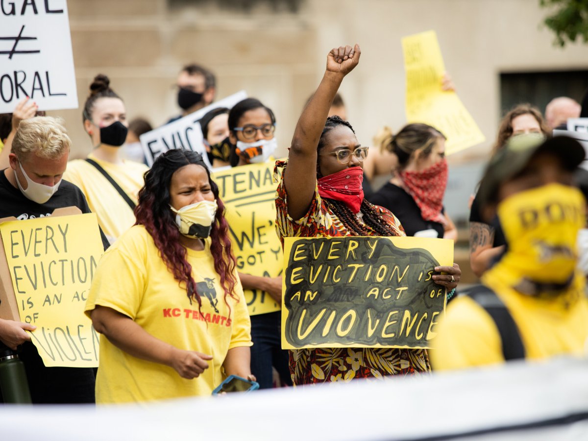 a group of protestors caring sings reading "everyeveiction is an act of violence" and "legal =/ Moral"