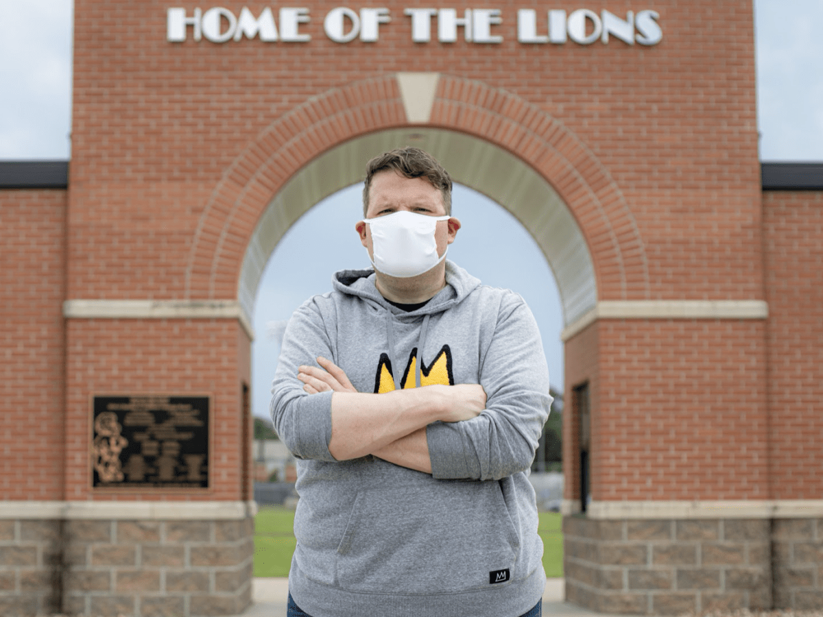 Craig Fisher, stands in front of Lawrence High School in Lawrence, Kansas where he teaches English and theater.
