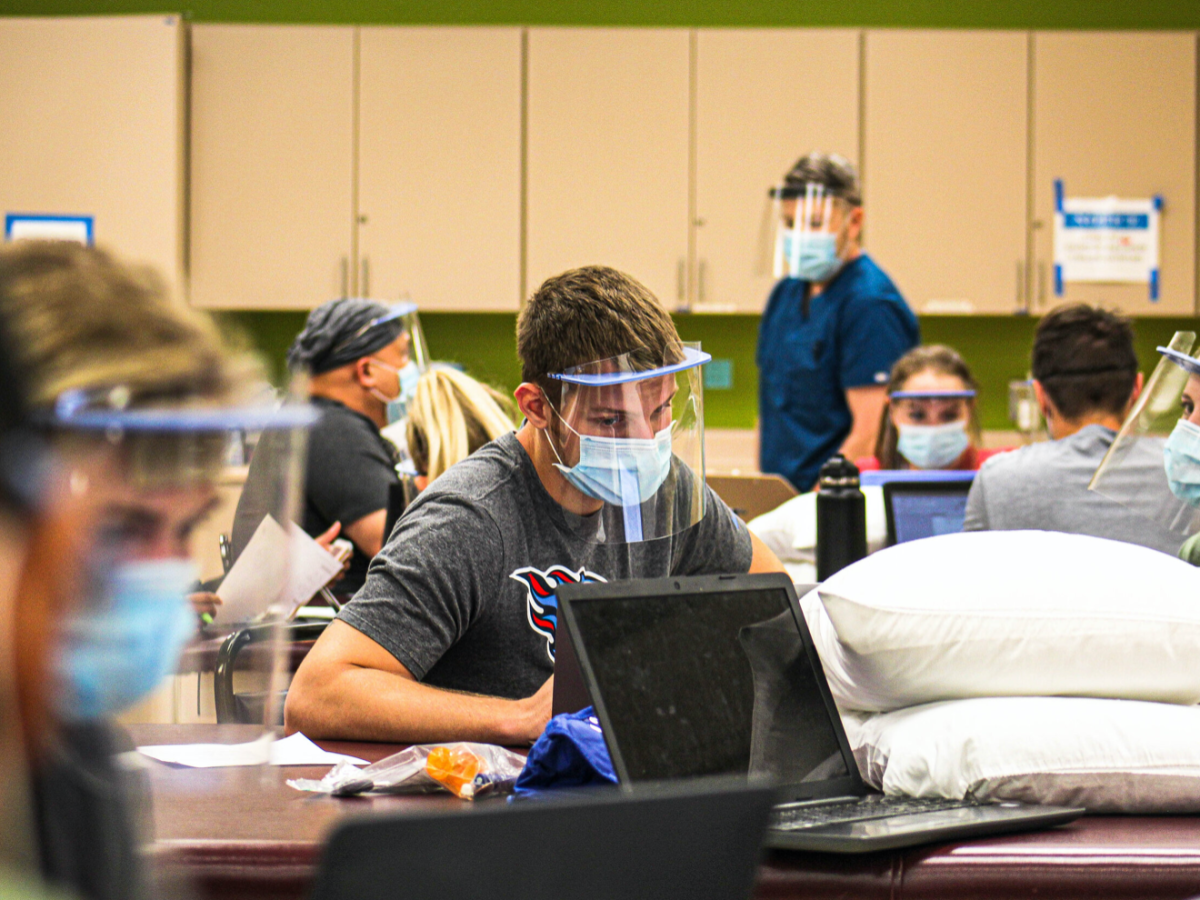 Returning physical therapy students at Rockhurst University wore protective gear and took safety precautions during an in-person lab for the first week of classes. Zachary Linhares/The Beacon