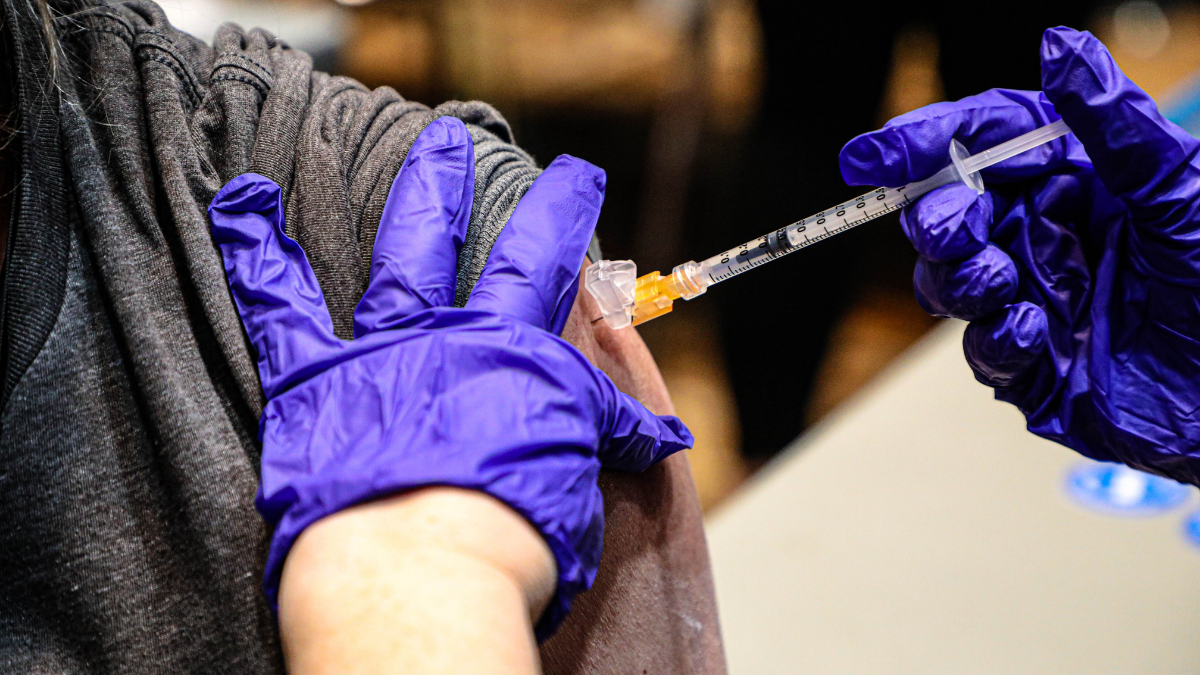 Image of Covid-19 vaccination syringe going into an arm