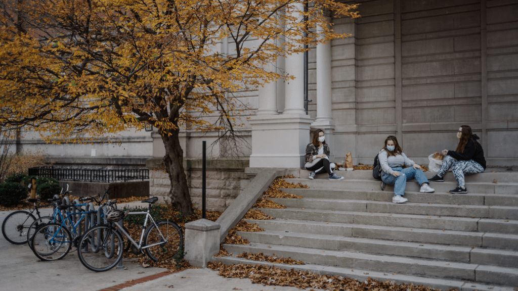 From left, University of Missouri juniors Devon Terry, Sydney Greenfield and MaryRose Ornosky eat food and hang out at Jesse Hall on Tuesday Nov. 10, 2020, on MU’s campus. When the sun set, the three students departed separately. Jacob Moscovitch/The Beacon