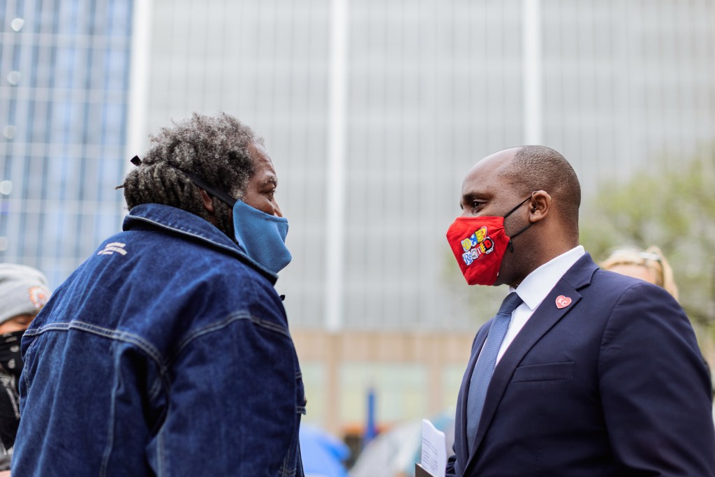 From left: Qadhafi, leader of the Kansas City Homeless Union, talks with Kansas City Mayor Quinton Lucas on April 7 in front of City Hall following another meeting to discuss the Homeless Union's demands.