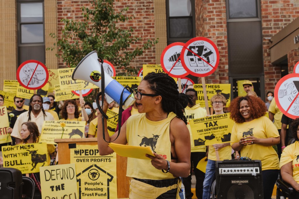 Jenay Manley gives a speech using a bullhorn during KC Tenants' rally on June 26 to present its plan for a People's Housing Trust Fund.