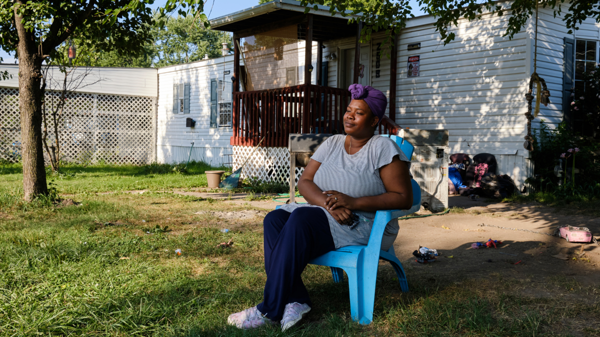 Heart Mobile Village resident RoNisha Rogers sits in front of her home.