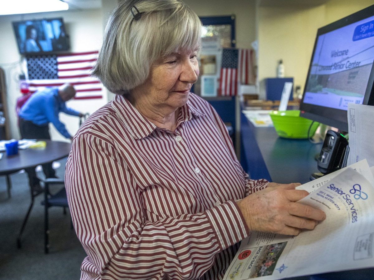 Diane Pope, who attends the Linwood Senior Center, reads the senior center's newsletter. (Alex Unruh/The Beacon)