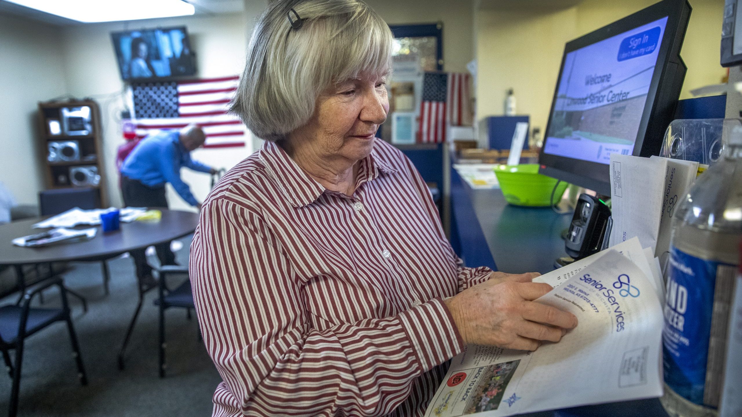 Diane Pope, who attends the Linwood Senior Center, reads the senior center's newsletter. (Alex Unruh/The Beacon)