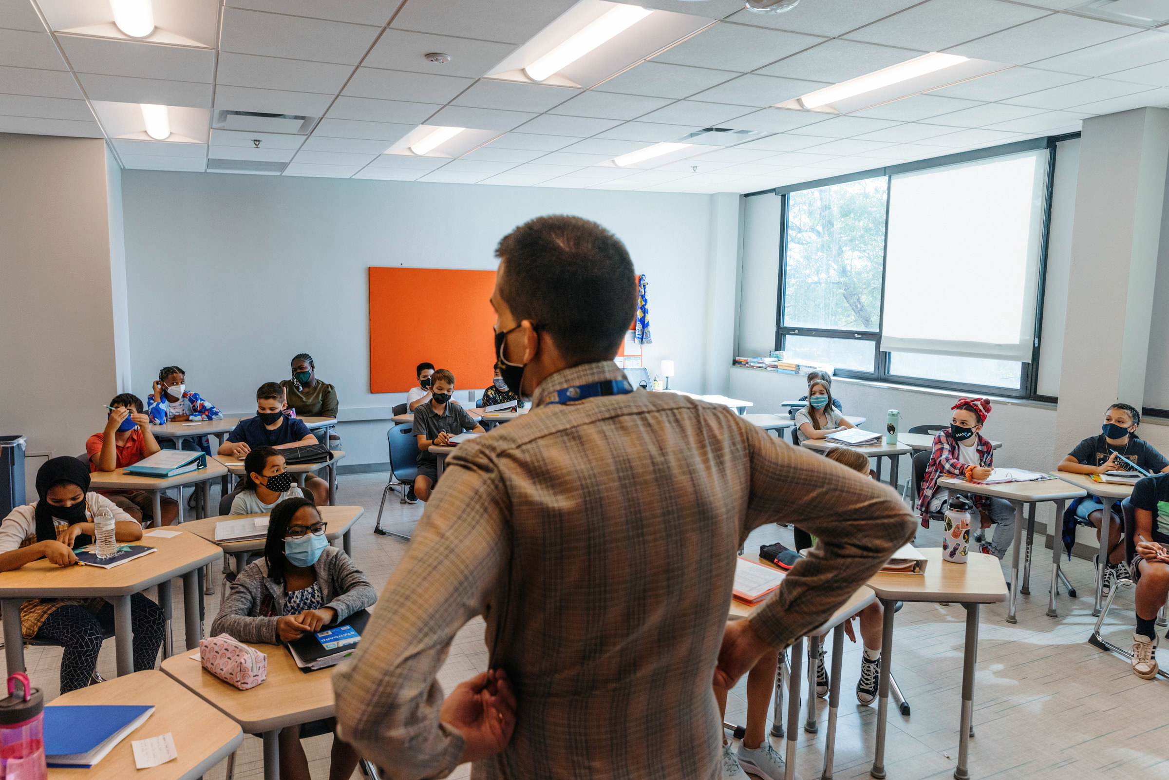 A teacher addresses a class at Lincoln Middle School on the first day of school, Aug. 23, in Kansas City. Like most KC-area school districts, Kansas City Public Schools requires masks.