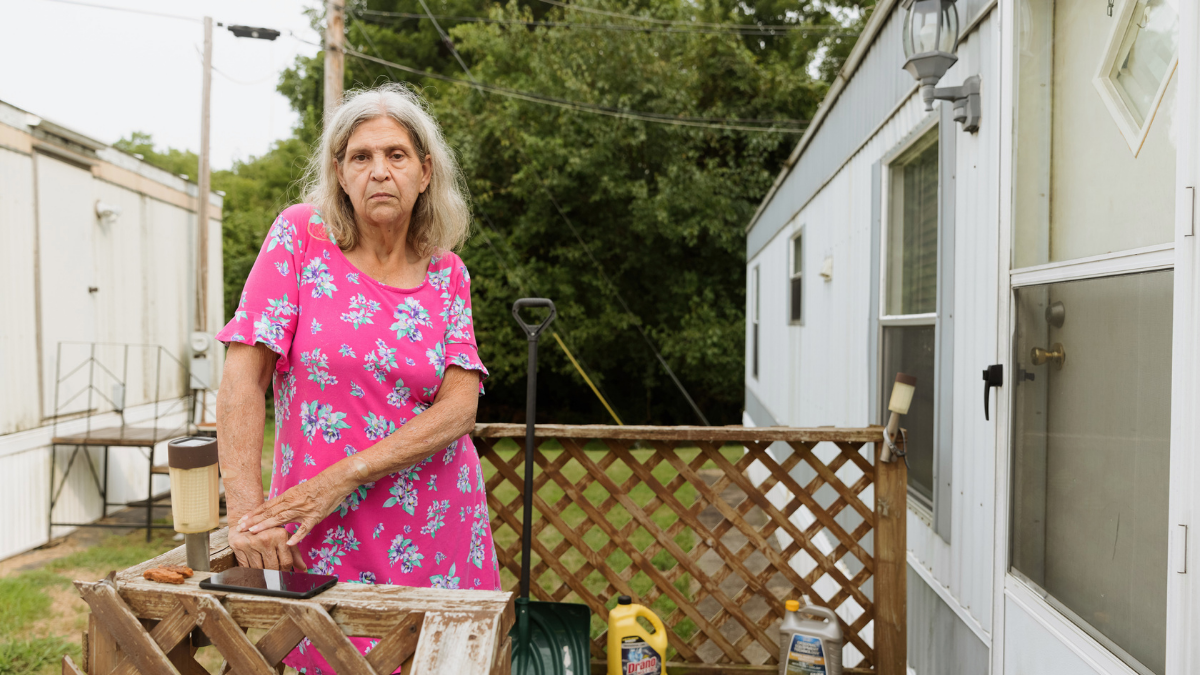 Jacqueline Young on the front porch of her rental home at Autumn Falls mobile home park. The park is owned by Tovia Capital, LLC. Young received an eviction notice in August.