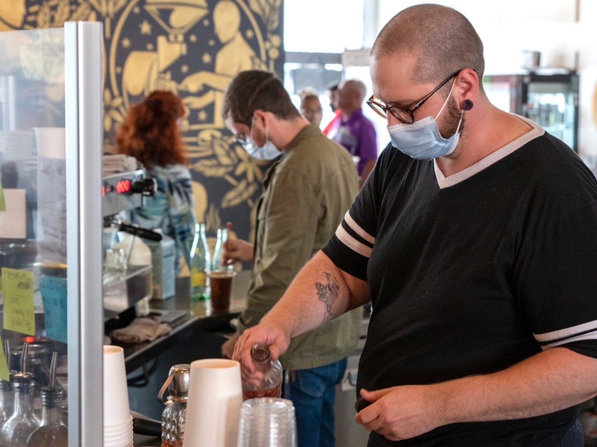 Employees at some local businesses — including Kyle Borger at Reverie Roasters, pictured here — choose to wear one. (Alex Unruh/The Beacon)