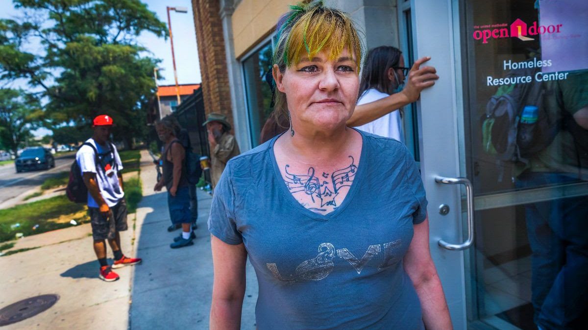 Charity Johnston waits outside of United Methodist Open Door, 402 E. 2nd St., on Tuesday afternoon. It serves as a resource center for those without permanent homes by providing hot showers, a laundry service and a place to rest or eat. (Fernando Salazar/The Wichita Beacon)