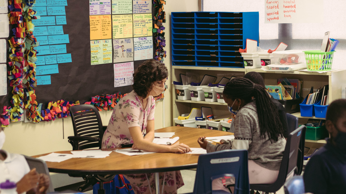A teacher works with a small group of students in a fourth grade classroom at Garfield Elementary School in Kansas City.