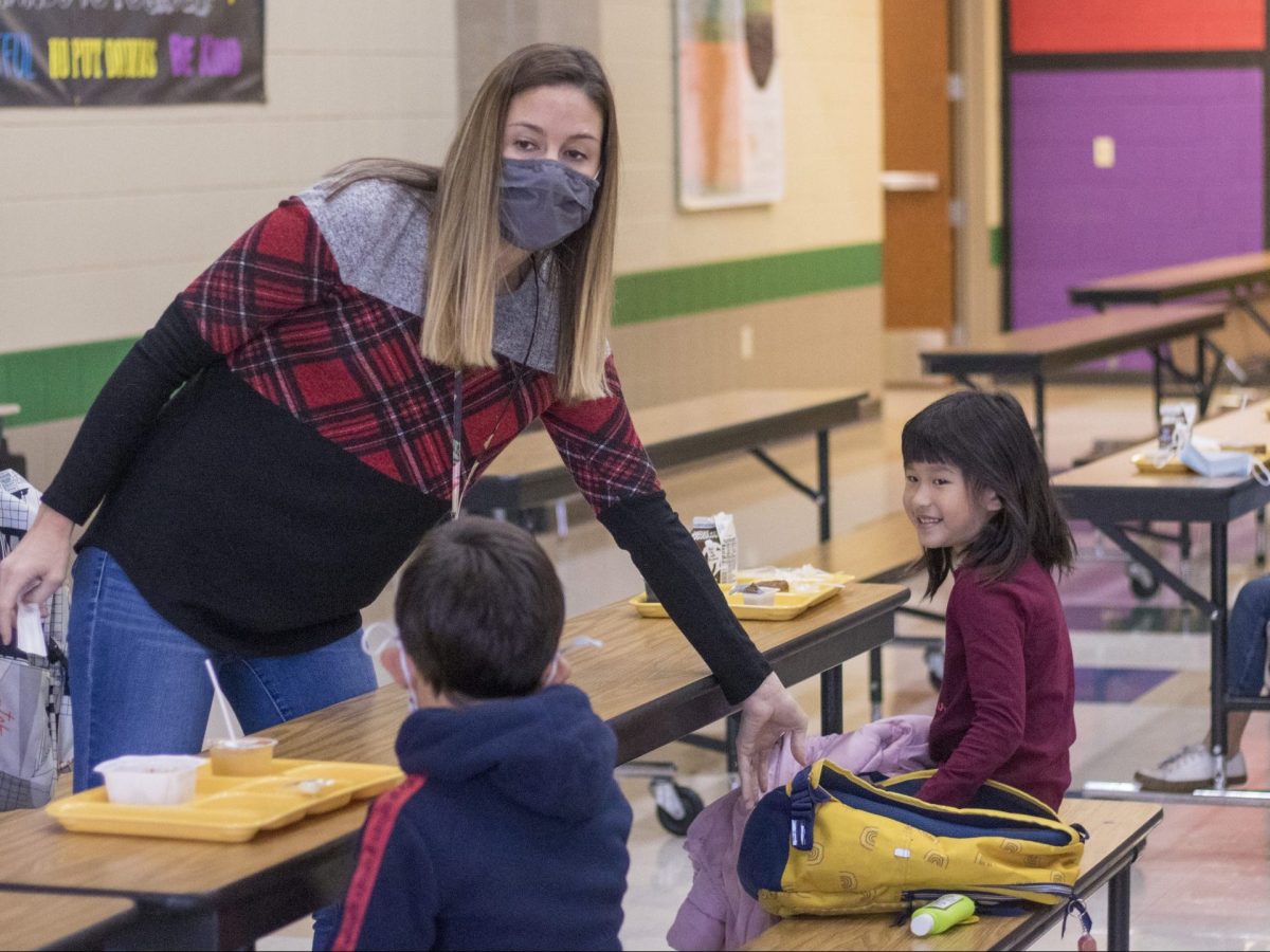 Even on the rare days Prairie Creek Elementary doesn’t need her to substitute teach, Jennifer Eimers still helps out elsewhere in the building. On Wednesday, she supervised breakfast and helped a student pour chocolate milk onto his Lucky Charms. (Rafael Garcia/The Beacon)