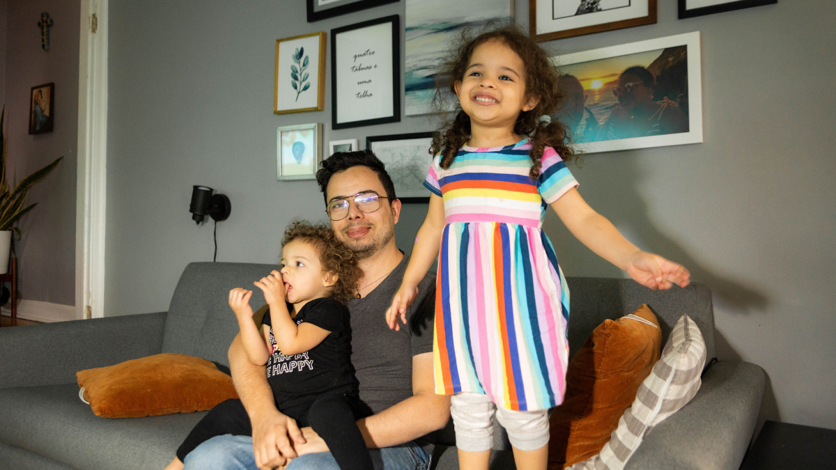 Bruno Silva and his two kids, Summer and Olivia in their living room.