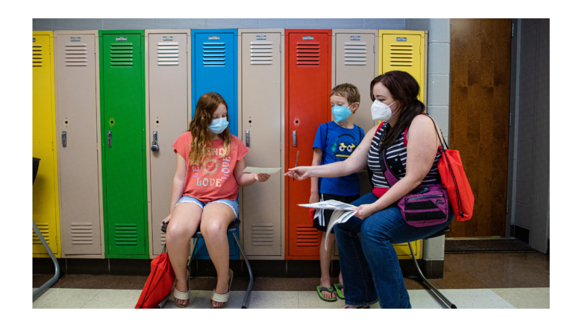 Desiree Martin and her children Hayden, 8, right, and Elliot, 11, are pictured July 28 at an enrollment fair held by Kansas City Public Schools at Manual Career and Technical Center in Kansas City.