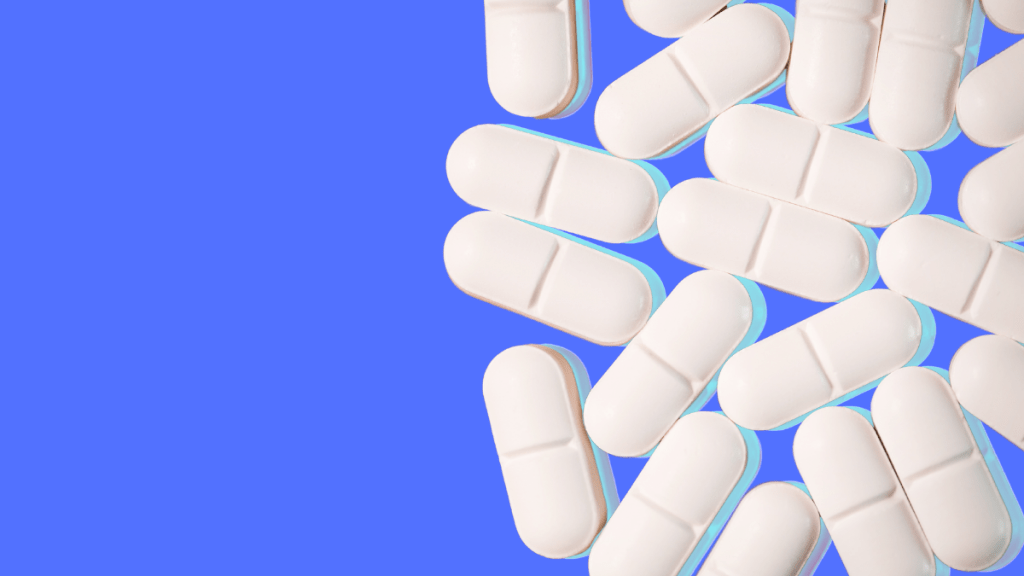 White pills on blue background