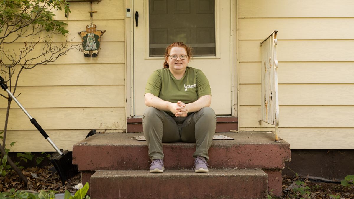 Ava Anderson sits outside her home in Gladstone. Anderson was hired in the distribution department of Children's Mercy Hospital after she completed the Project SEARCH internship program through North Kansas City Schools.