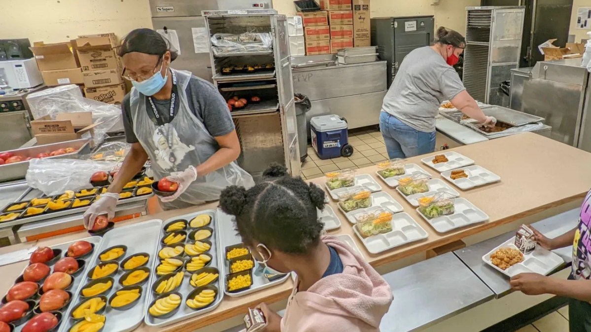 Wichita students walk through a lunch line picking up meals provided by the school district.