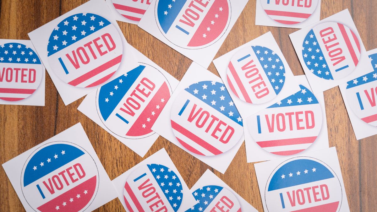 I voted stickers on a wooden table.