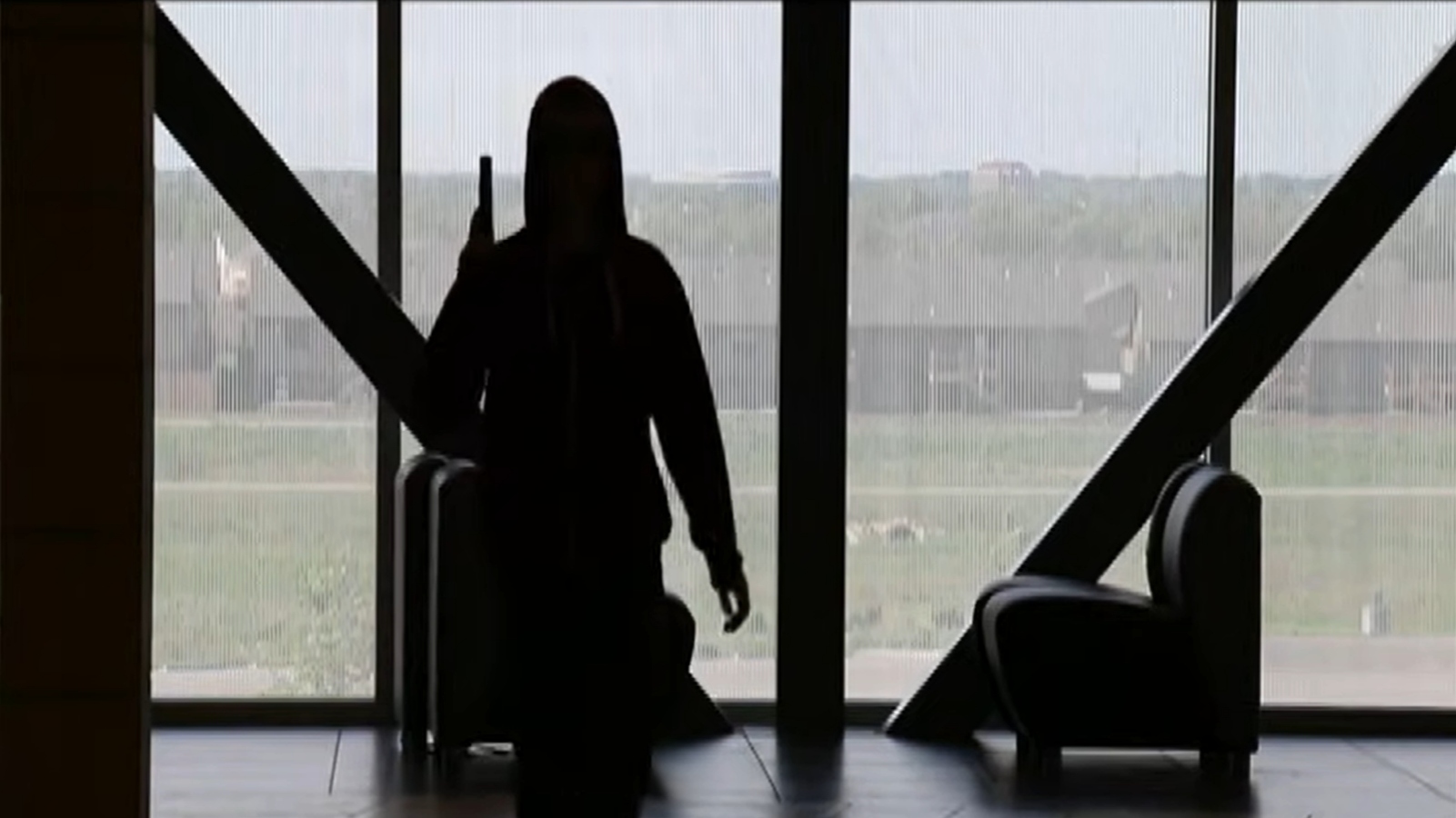 A silhouetted figure stands in a hallway in the USD 259 training video for Wichita school safety.