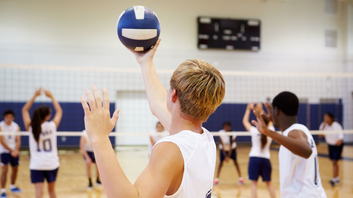 A student hits a volleyball among teammates in a file image.