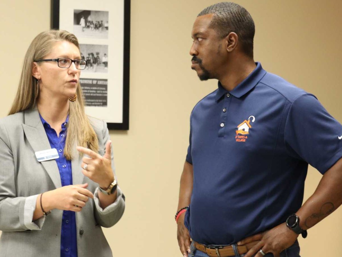 School board member Diane Albert and City Council member Brandon Johnson talking.