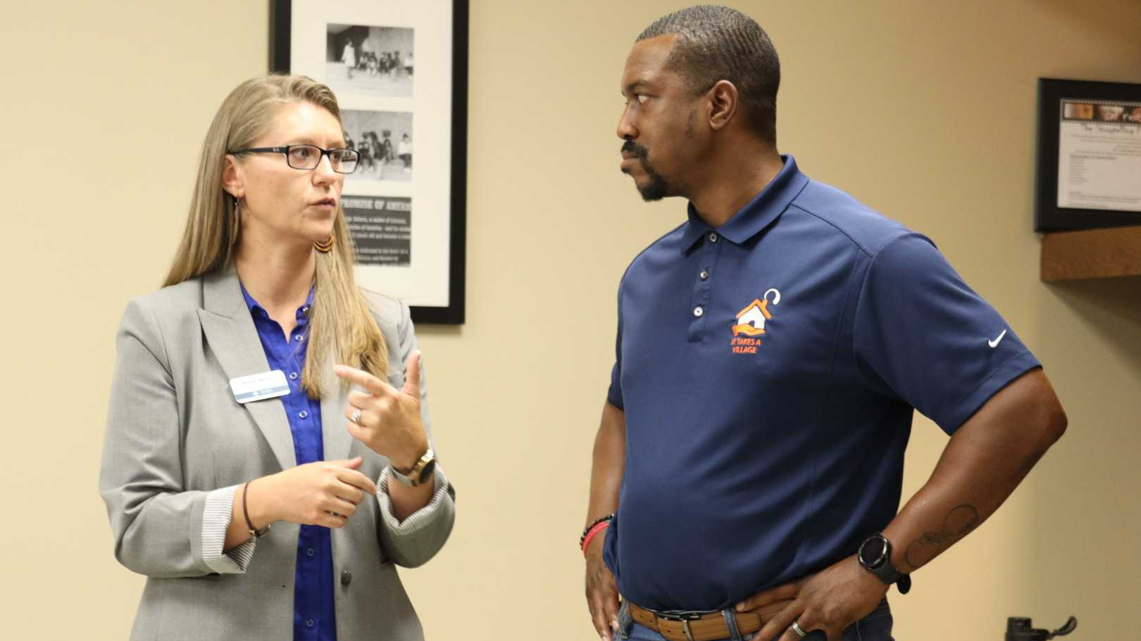 School board member Diane Albert and City Council member Brandon Johnson talking.