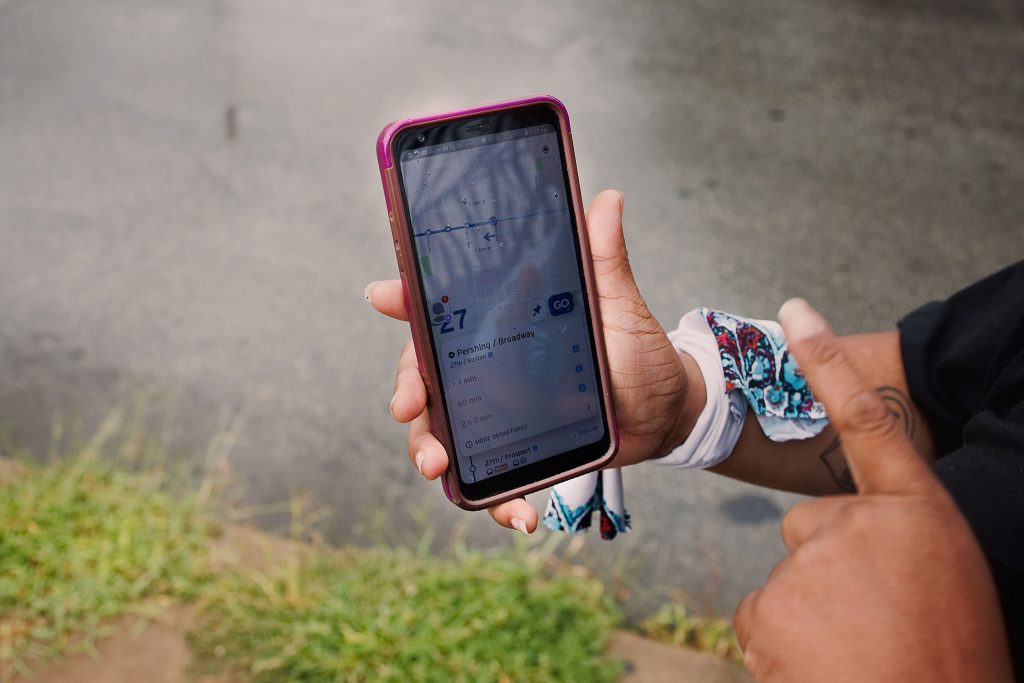 Person checks RideKC’s app to see how far away her bus is.