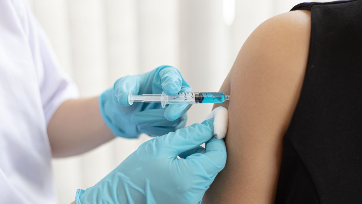 covid booster being administered on arm.