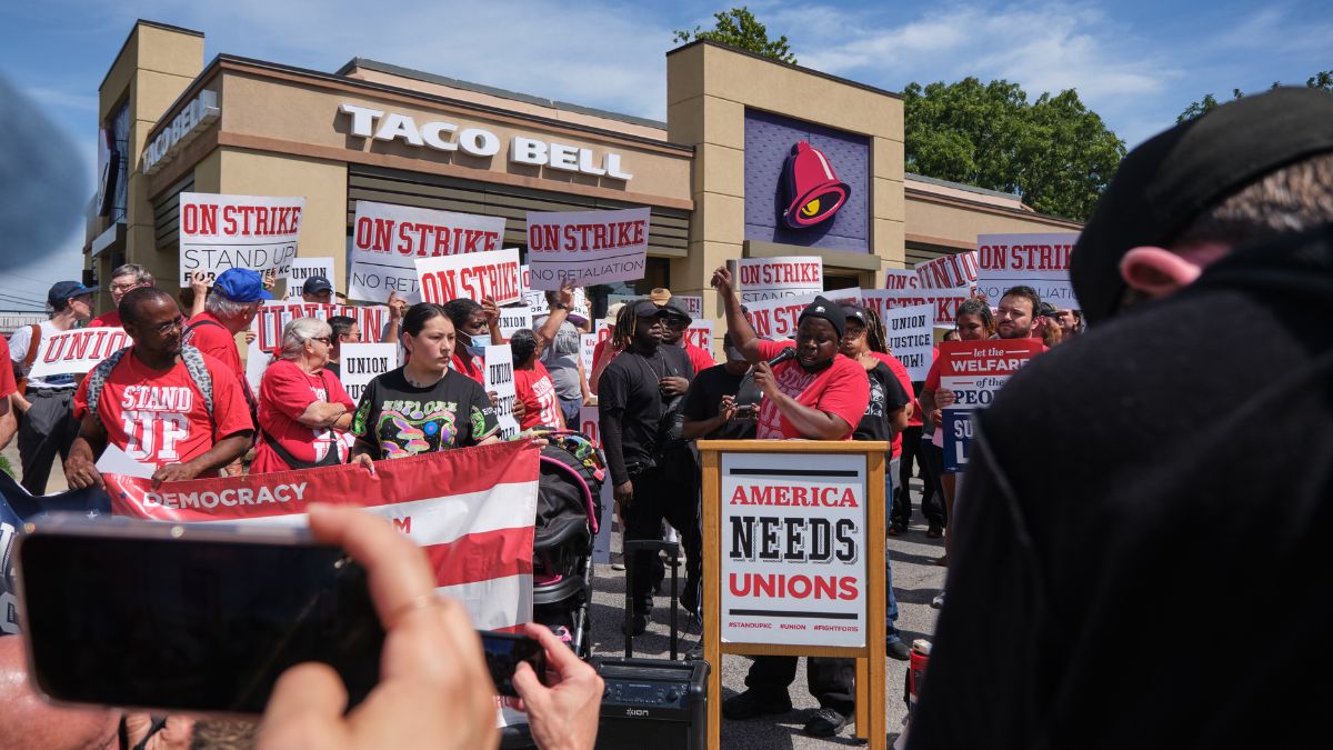 Protesters gather around a podium during a rally held after the walkout.