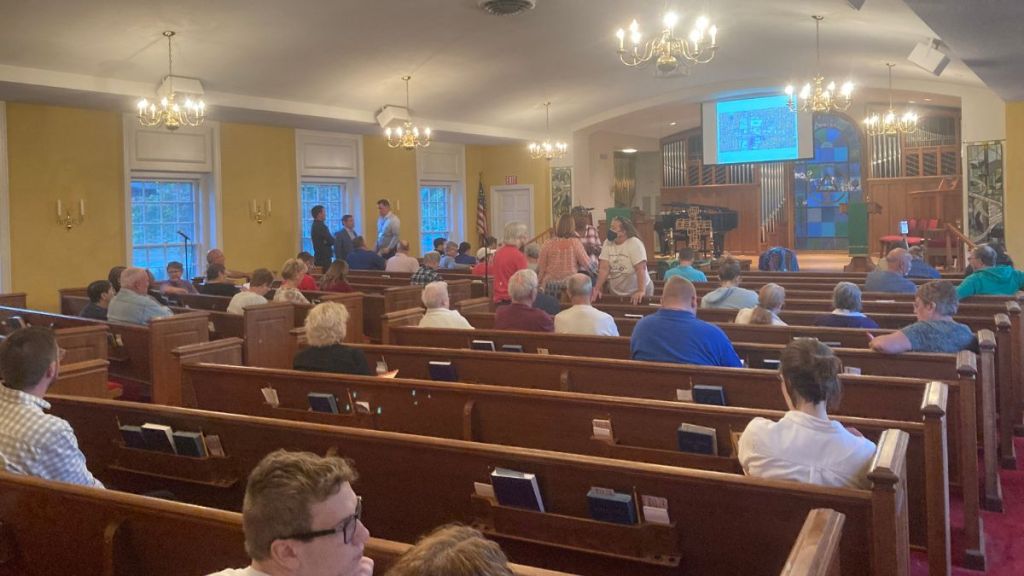 Around 40 residents sit in a church sanctuary for a neighborhood association meeting to discuss Waldo74Broadway.