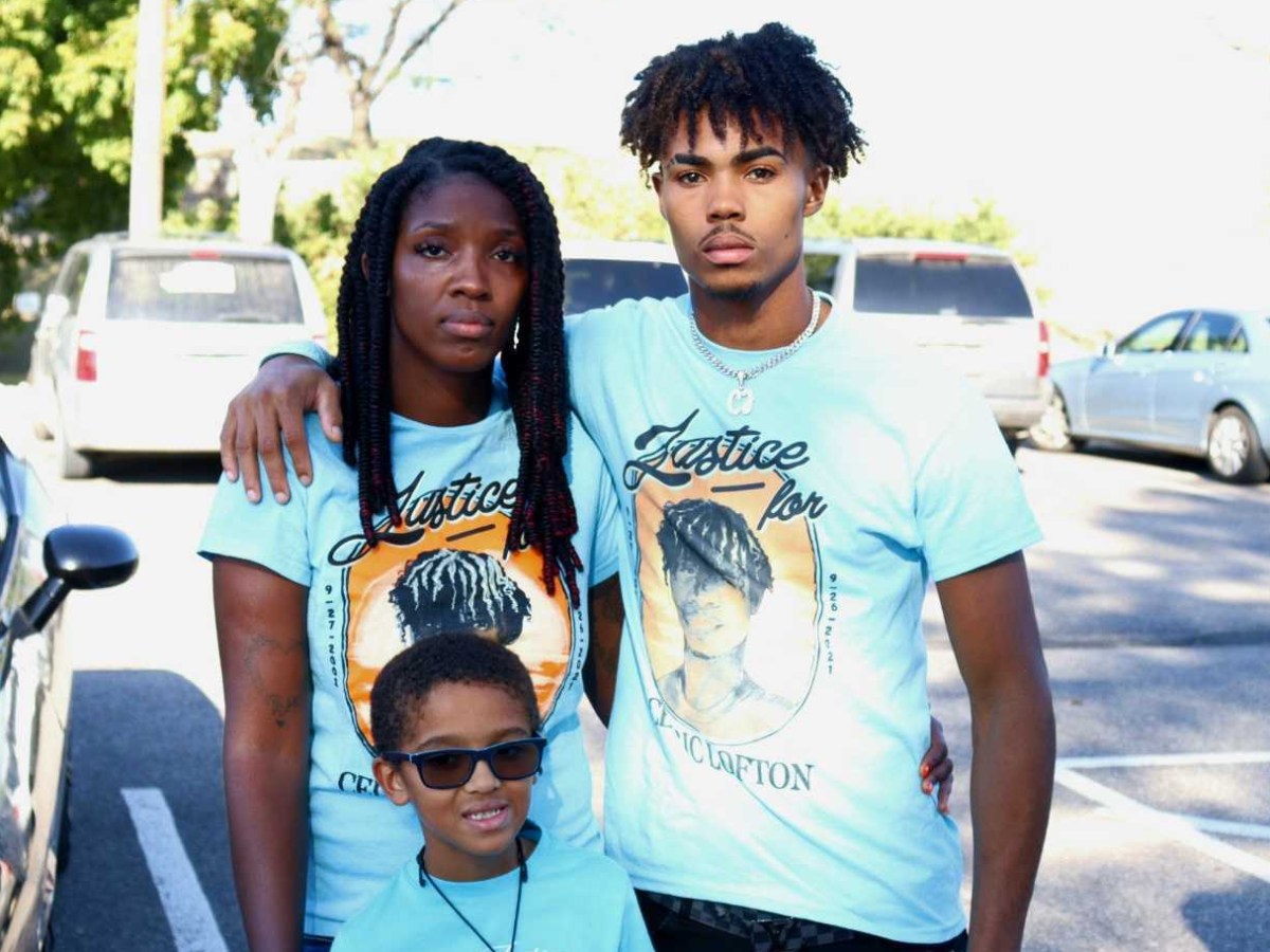 Gennieve Floyd, Cedric Lofton’s cousin, and Mark Teetz, Lofton’s brother holding each other in a parking lot in front of JIAC.