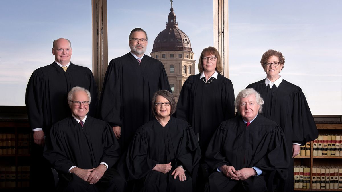 Kansas Supreme Court justices posed with the capitol in the background