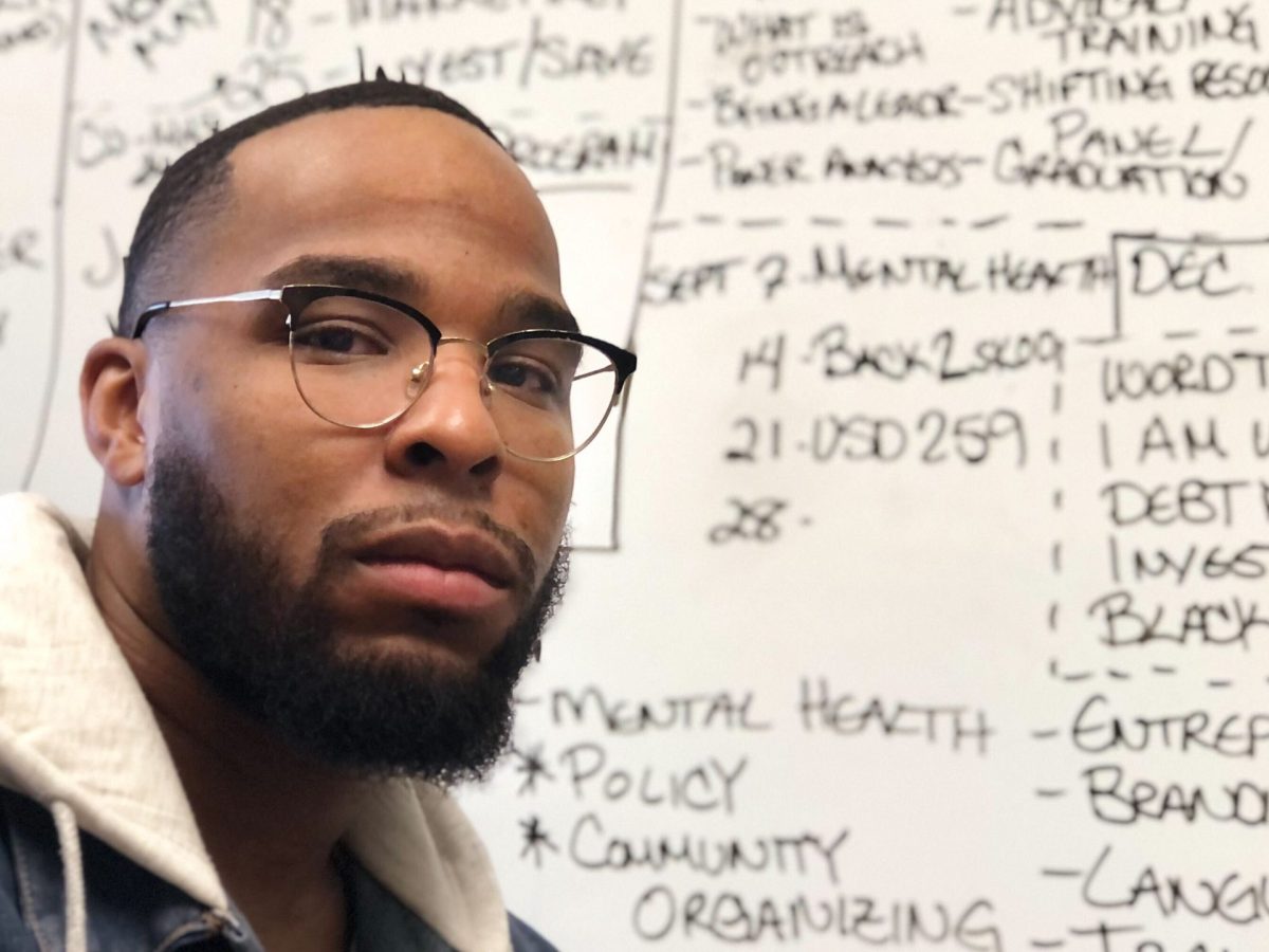 Desmond Bryant-White in front of a white board in his office at Progeny