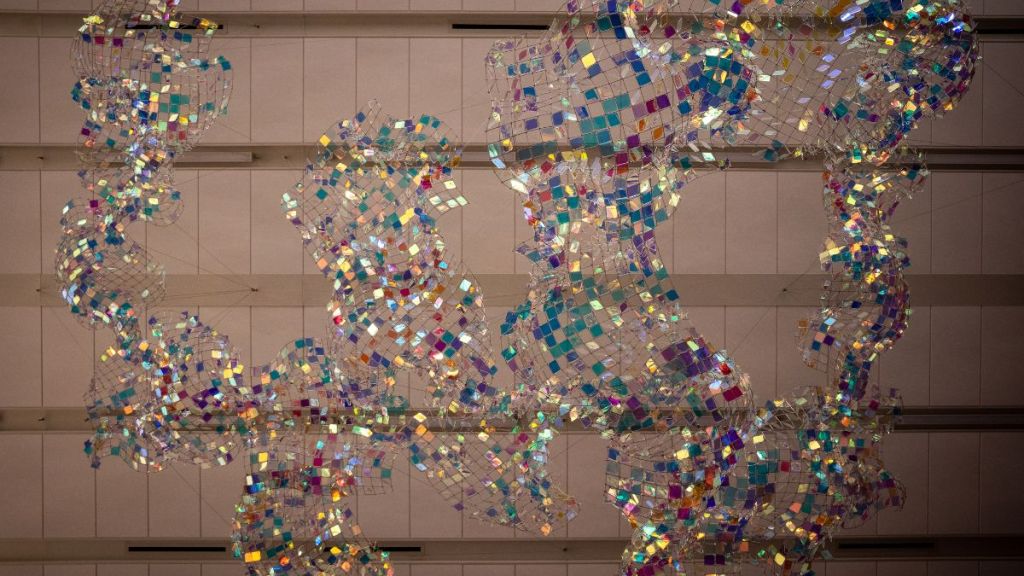 A hanging sculpture in the KCI terminal, made out of wire and multicolored stained glass.