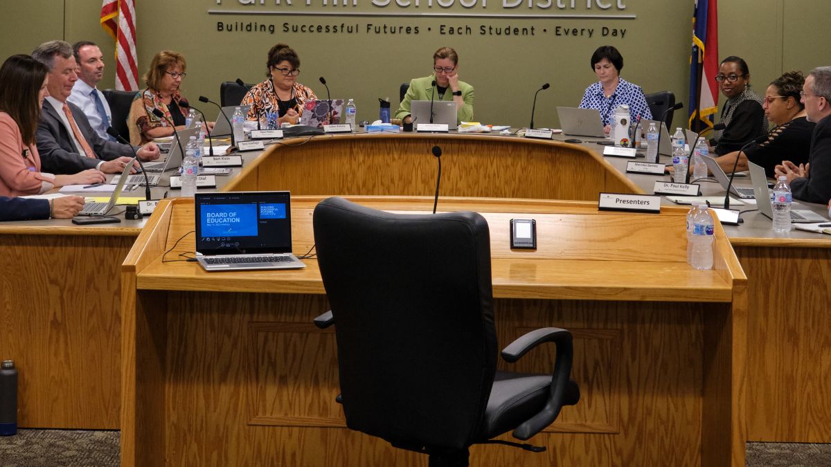An empty chair during a school board meeting