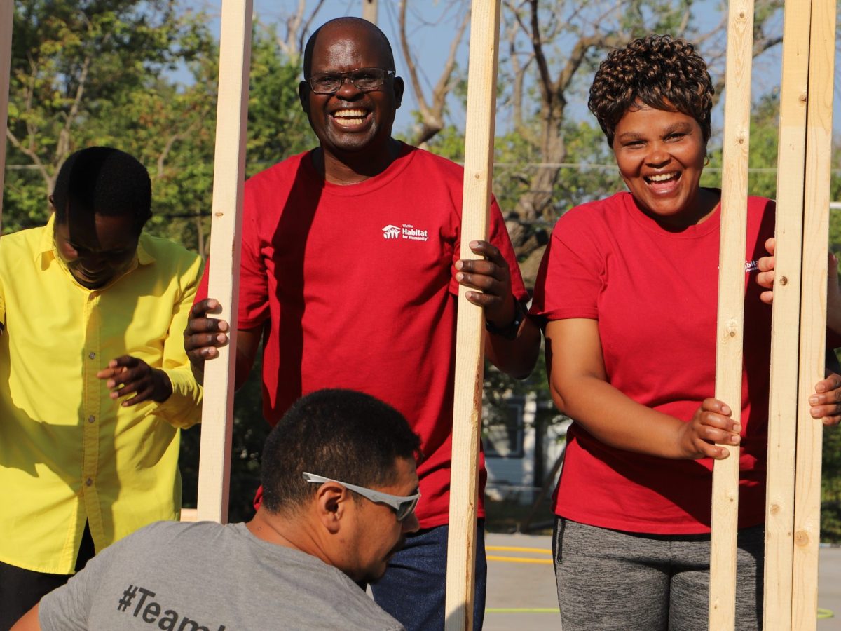 Gédéon Jino, a refugee from the Congo, at the wall-raising ceremony with wife Francine.