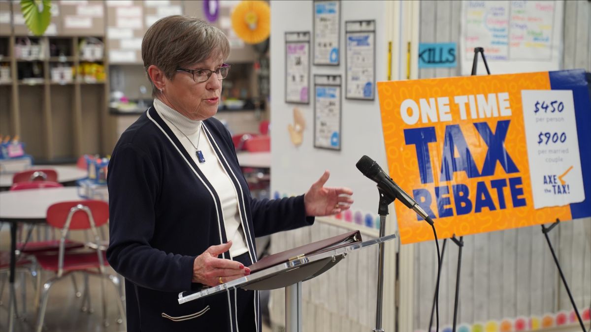 Nearly 30 bills received a Gov. Laura Kelly veto in the 2023 Kansas legislative session, including a tax bill that would have resulted in major revenue cuts for the state. Kelly is pictured at a podium in an elementary school announcing her veto of the tax bill.