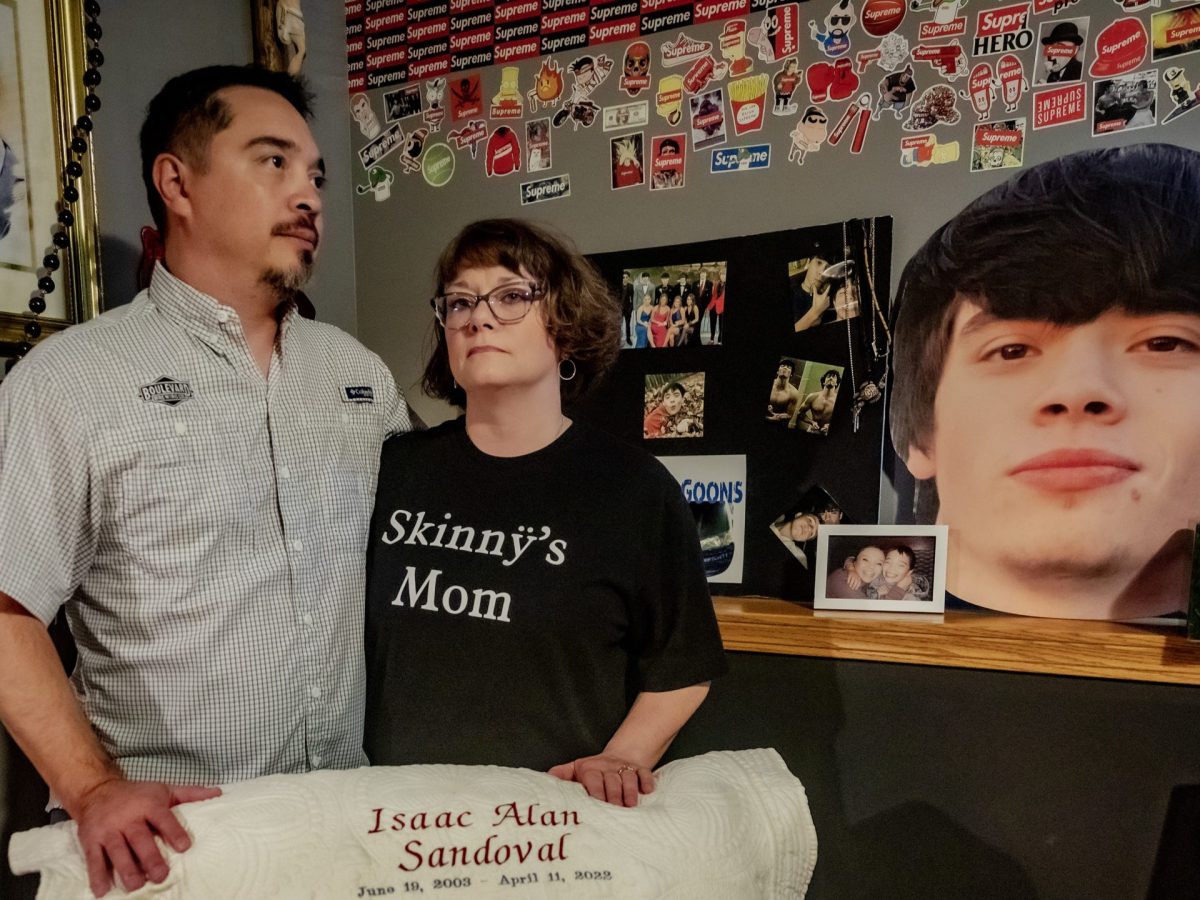 Mark and Val Sandoval stand in their son's bedroom, holding a pillow marking is birth and death dates. Isaac Sandoval was a victim of youth fentanyl death.