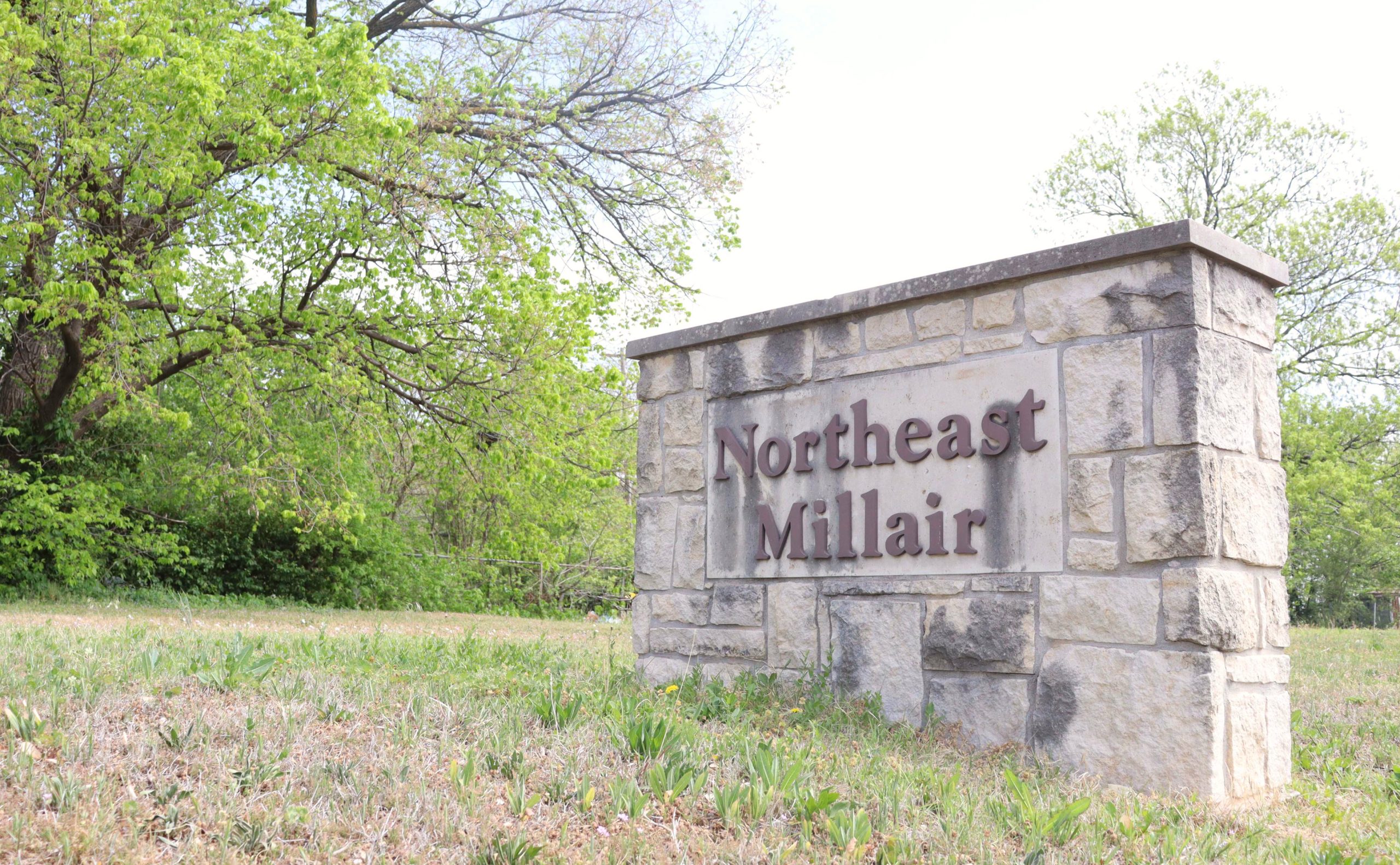 A limestone sign with Northeast Millair on it.
