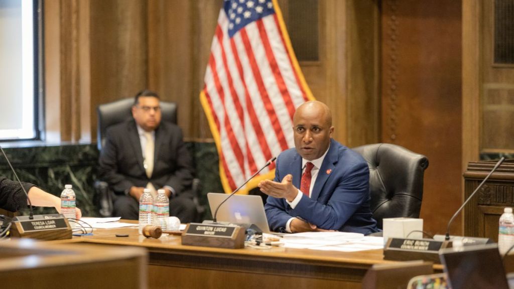 Mayor Quinton Lucas sits at a table in the City Council chambers.