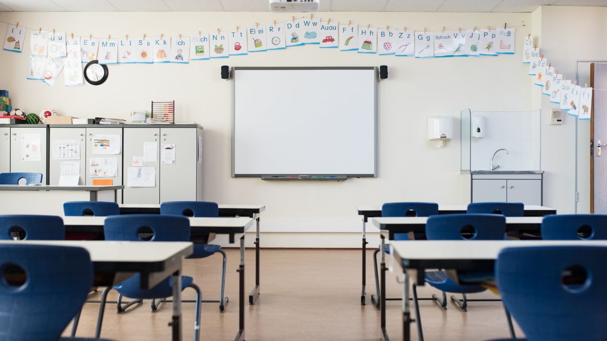 An empty classroom with a whiteboard