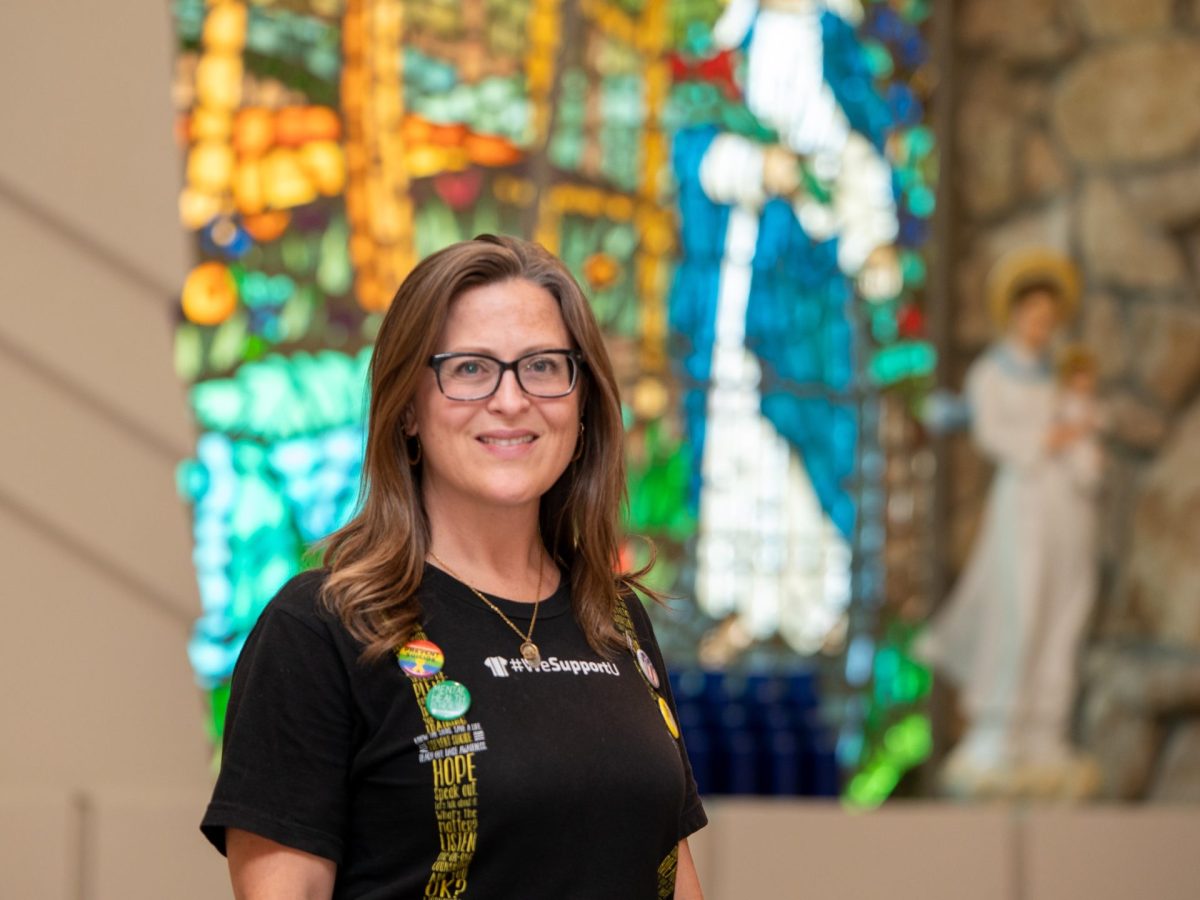 Jessica Provines stands in front of a stained glass window at a Catholic church where she spoke about suicide prevention.