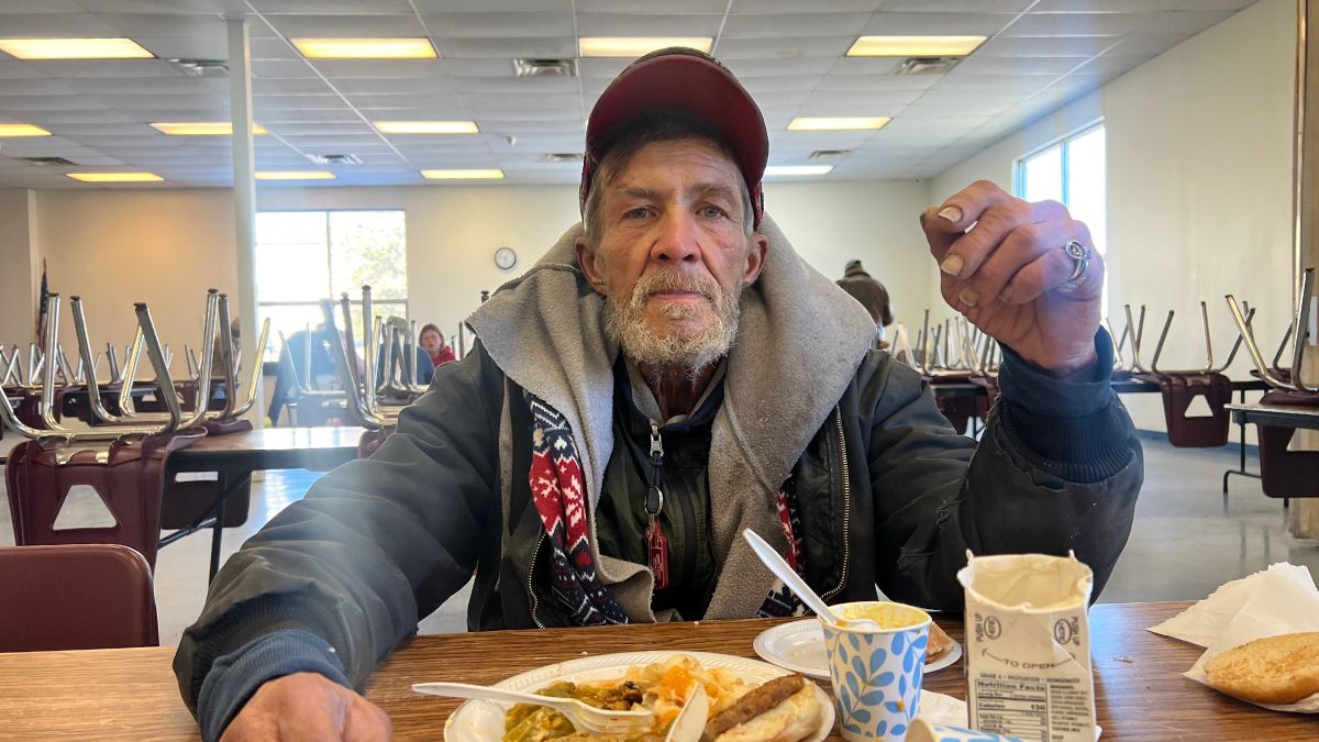 Scott Michael Cady eats lunch at a community kitchen.