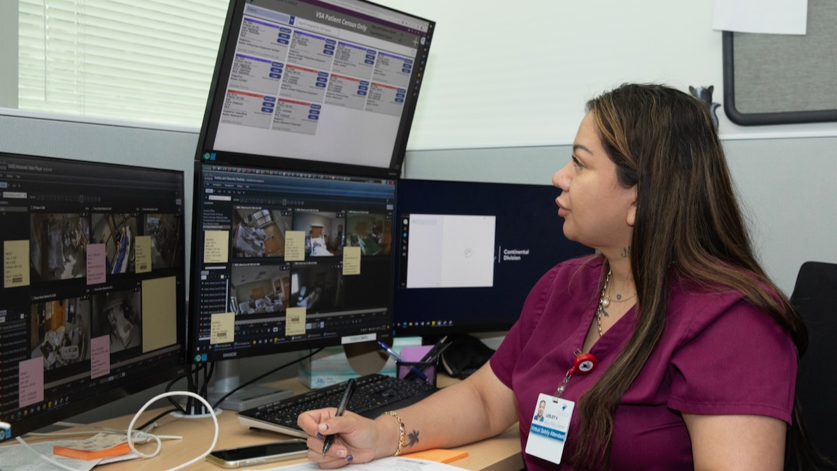 A health care worker monitors patients from HCA's virtual care center in Denver.