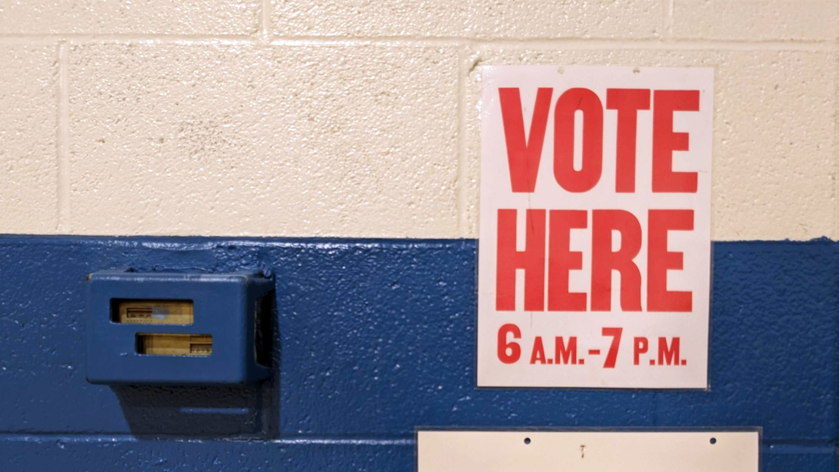 A "Vote Here" sign at a polling place.
