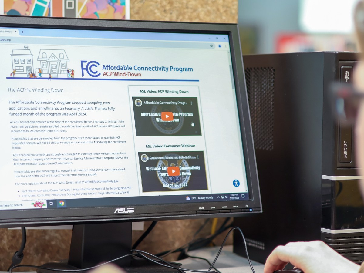 A person used the computer at the library.