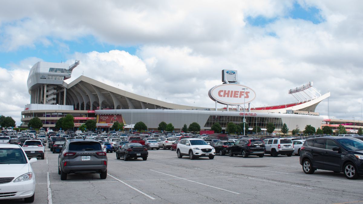 This is a photo of GEHA Field at Arrowhead Stadium with many cars parked in front. Six matches of the 2026 World Cup will be played at the stadium.