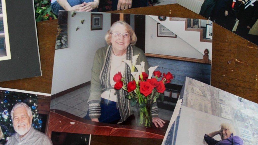 photographs scattered on a table. The main photo is of an older woman with red flowers.
